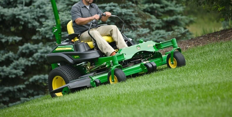 Mowing the lawn grass on a slope in Oak Creek Cutting Grass